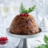 portrait image of steamed Thermomix Christmas pudding on light background.
