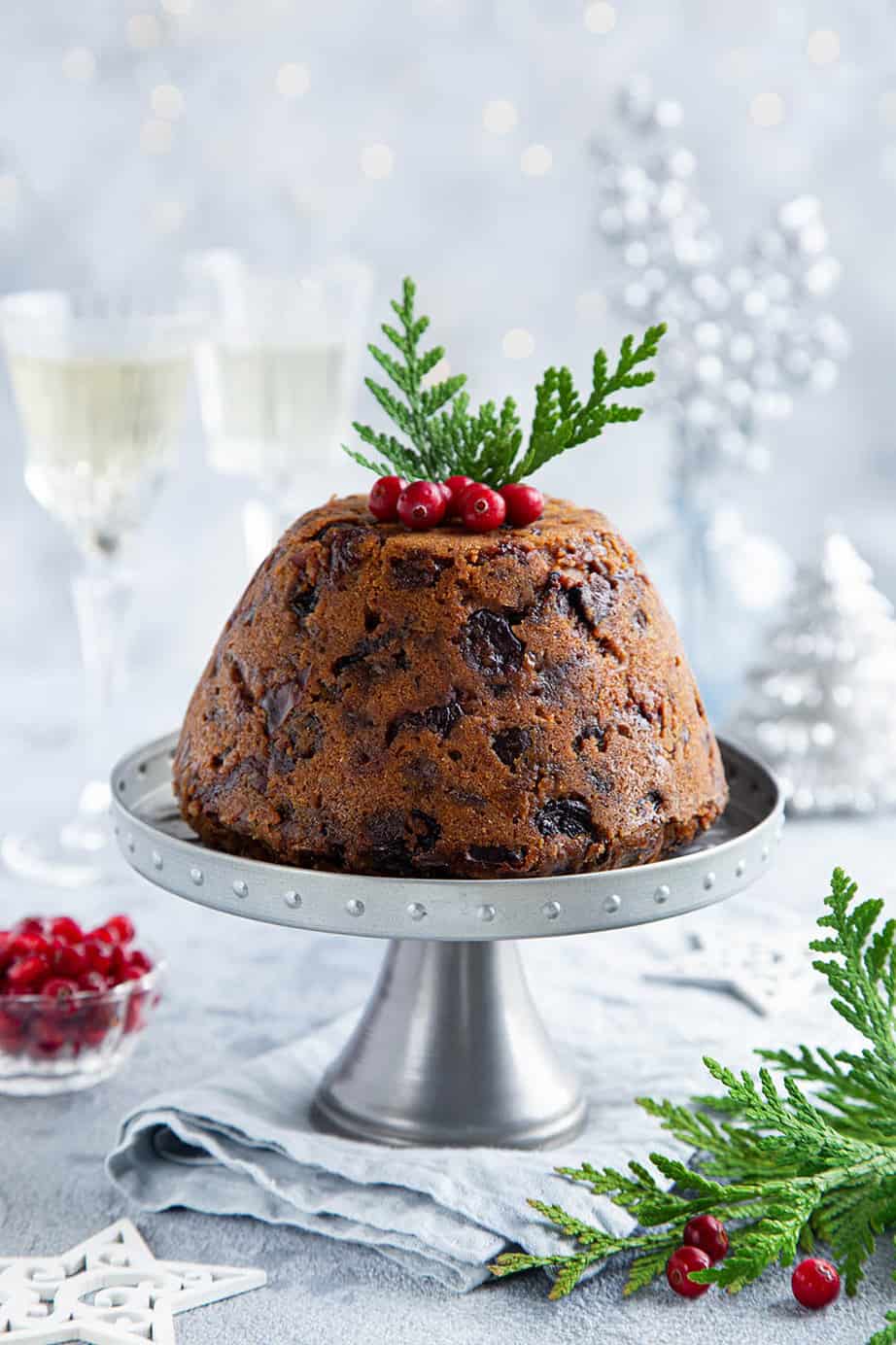 portrait image of steamed Thermomix Christmas pudding on light background.