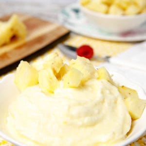 Portrait image of pineapple doles whip in a white bowl
