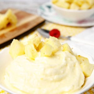 Portrait image of pineapple doles whip in a white bowl
