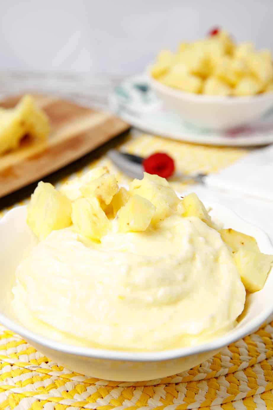 Portrait image of pineapple doles whip in a white bowl