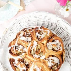 Portrait image sticky buns in white basket, overhead shot