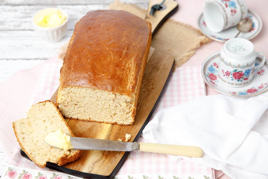 Loaf of peanut bread on pink checked tea towel