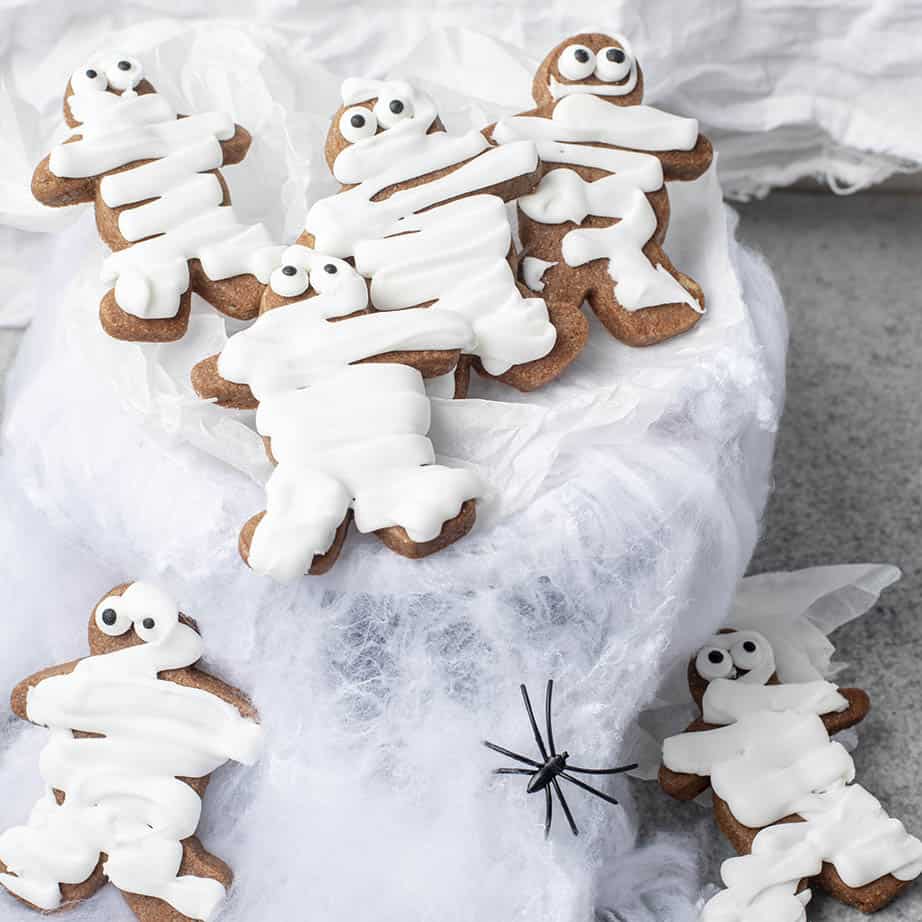 Spooky mummy cookies on a white background with spiders