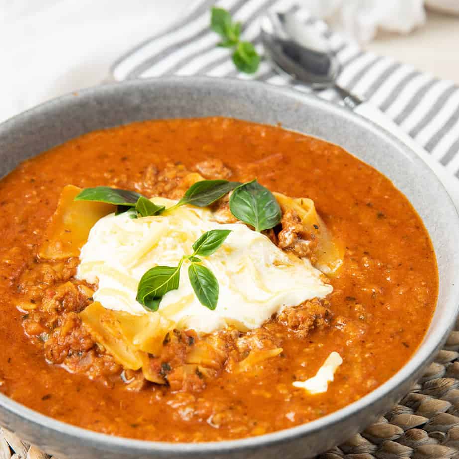 Close up square image of a lasagne soup and cheese topping