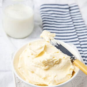 Homemade butter pictured with homemade buttermilk on a table setting