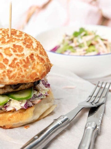 A Thermomix Burger on a white table setting with coleslaw