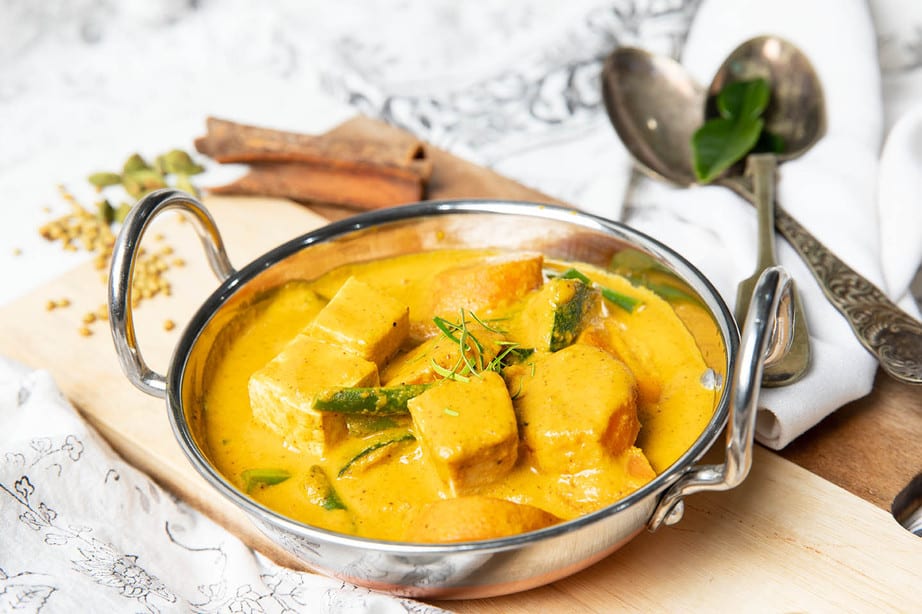 Vegetable curry in an Indian bowl with dried spices.