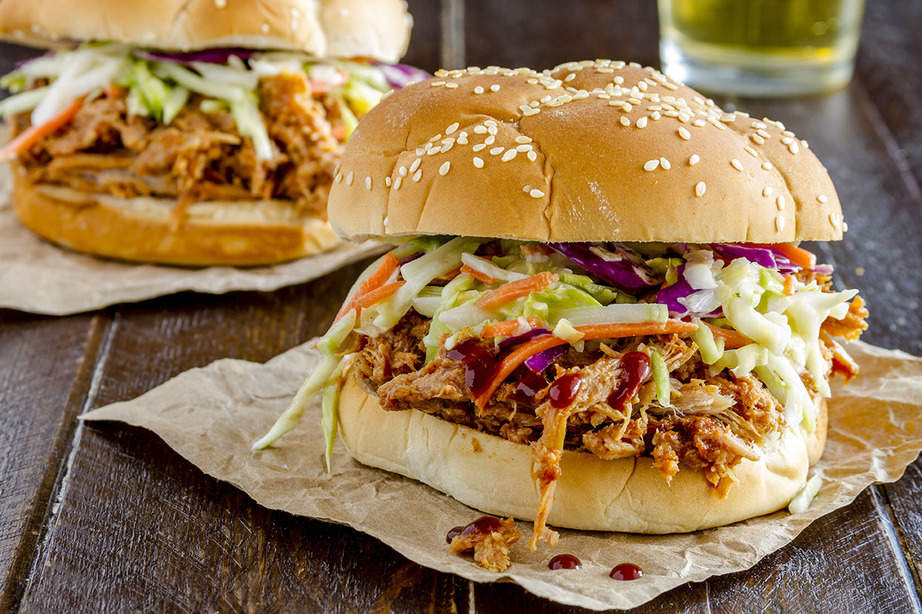 2 Pork burgers sitting on a table.