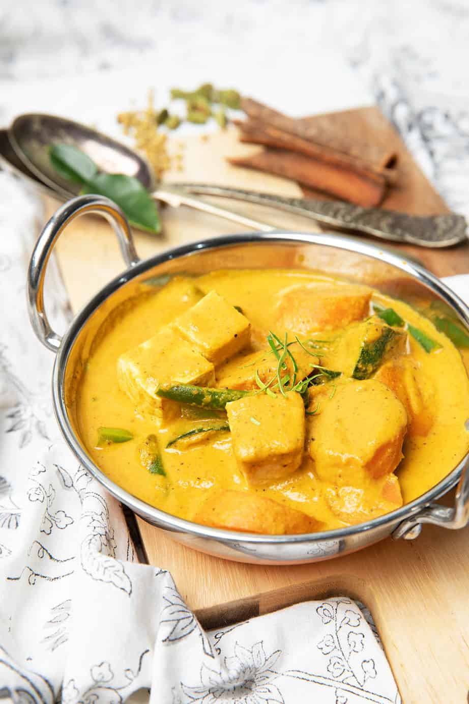 Portrait image vegetarian curry in a metal bowl.