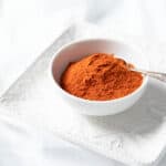 Ground Kashmiri Chili in a bowl on white background