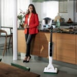 Kobold Vacuum mop system on the floor a woman standing by near the kitchen