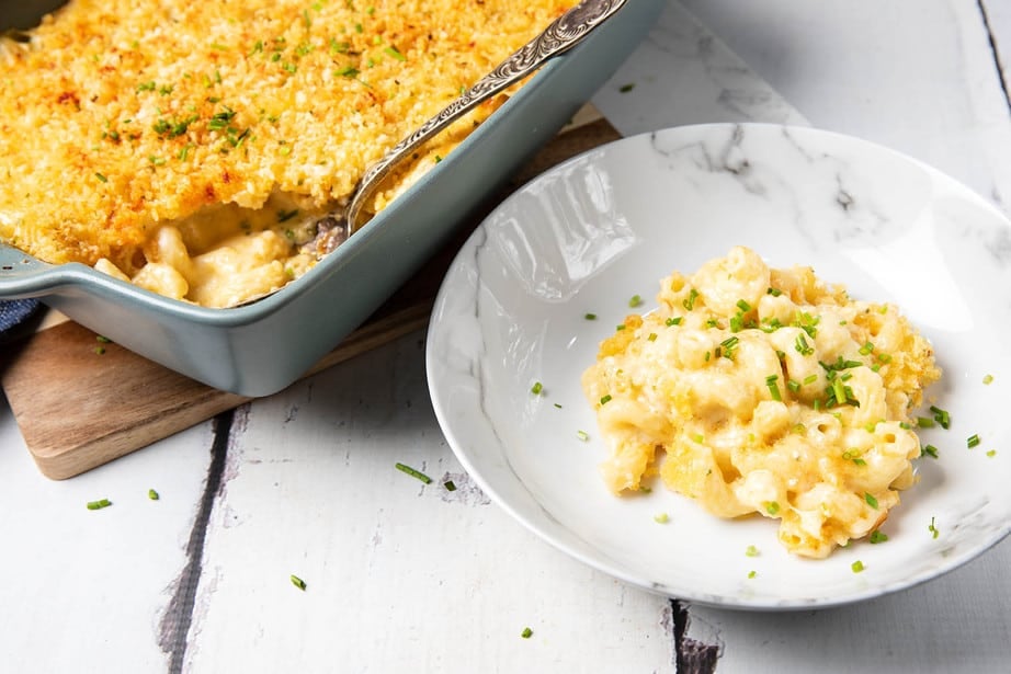 Macaroni Cheese served in a bowl alongside a baking tray