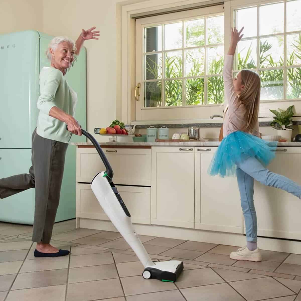 Kobold Vacuum VK7 cleaning the floor with a grandmother and child