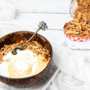 Healthy Granola in a coconut bowl with yoghurt and lemon curd