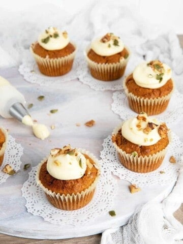 Carrot cupcakes thermomix on a white board with a frosting bag