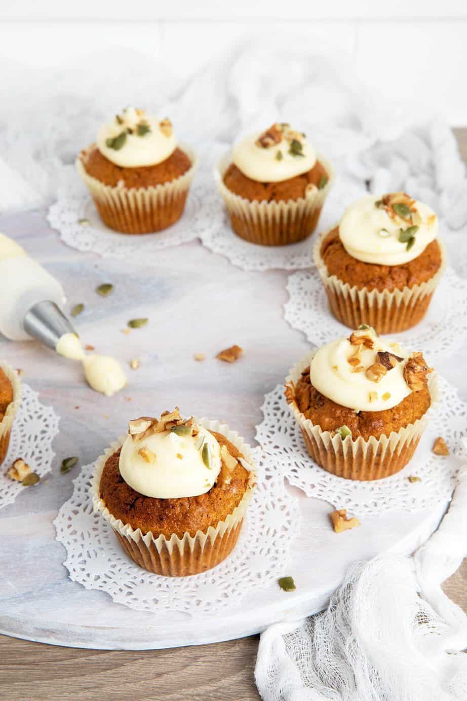 Carrot cupcakes thermomix on a white board with a frosting bag