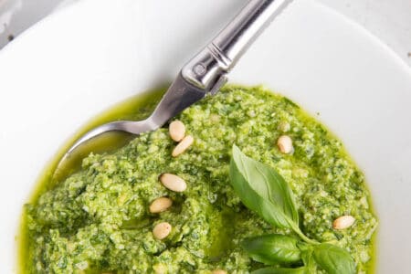 Thermomix pesto sauce in a white bowl and spoon