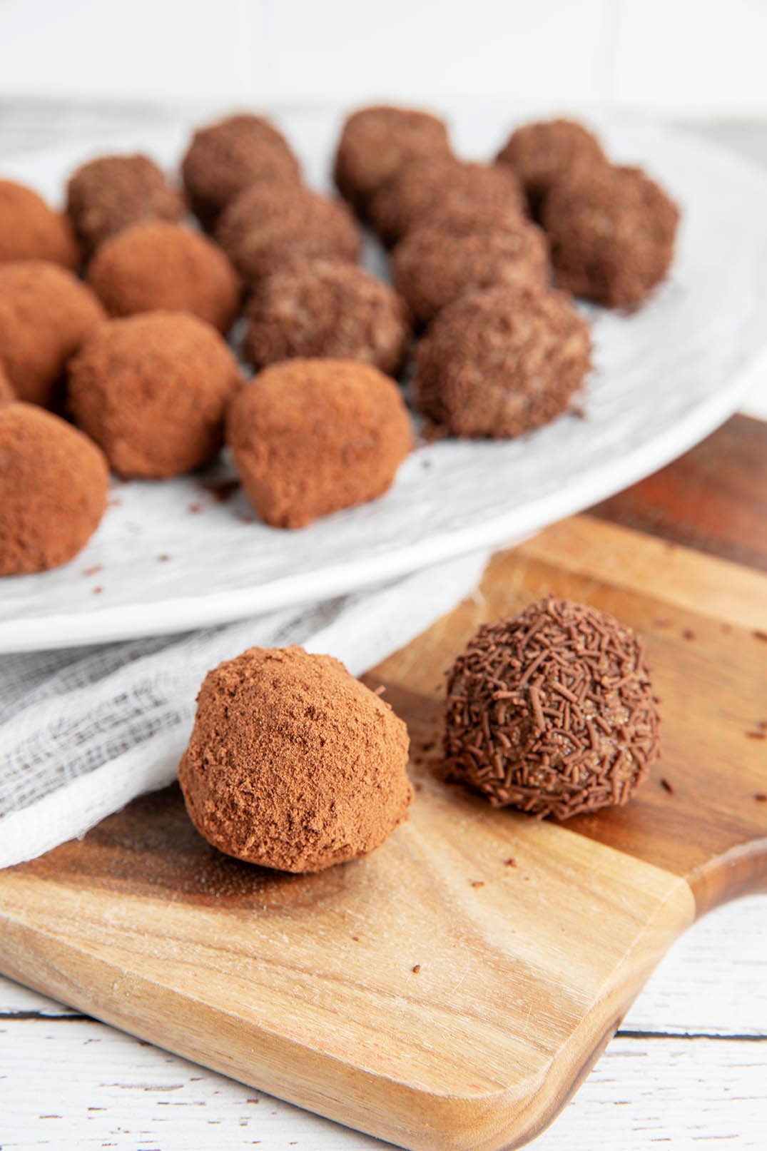 Weetbix Balls rolled in Milo and chocolate sprinkles on a white plate.