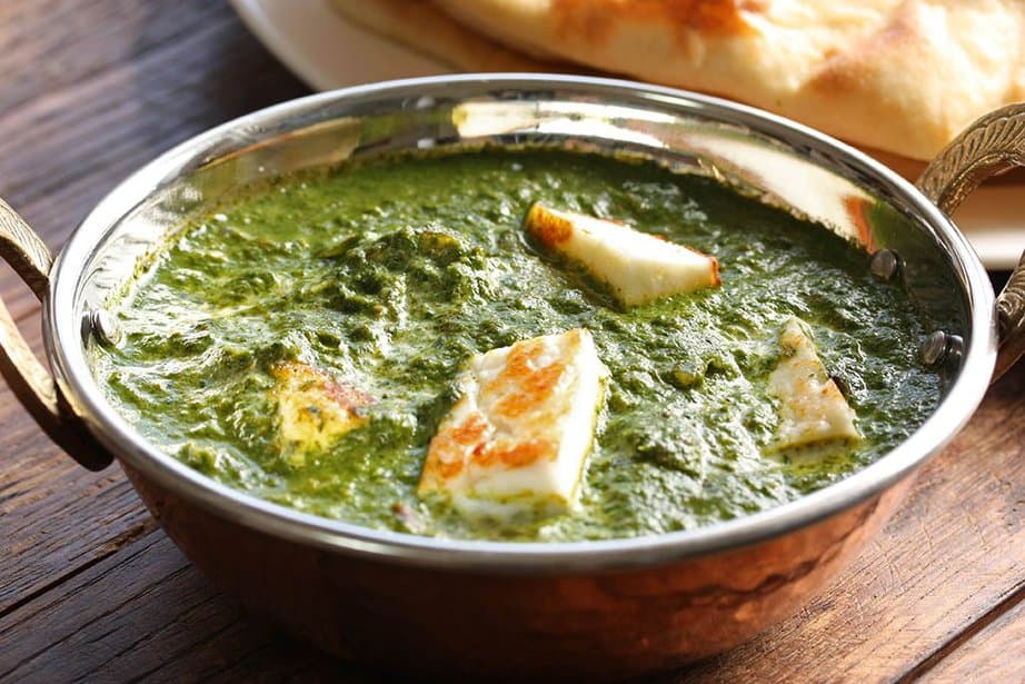 Vegetarian Indian Curry in a metal bowl, wooden table