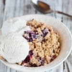 Apple crumble in a white bowl Thermomix recipe with Ice cream