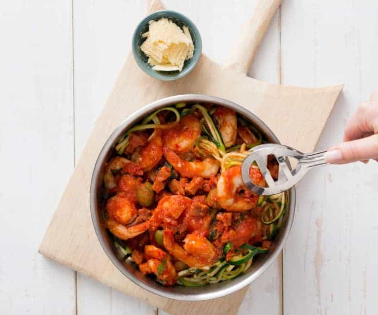 A bowl of prawn arabiatta on zucchini noodles served with parmesan cheese