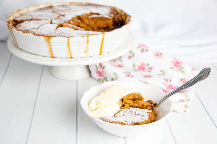 Butterscotch Pudding served in a bowl with ice-cream.