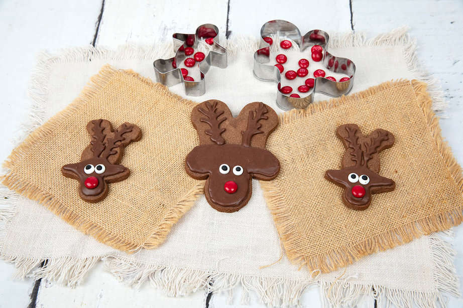 3 Chocolate reindeer cookies on a white and brown background, Christmas