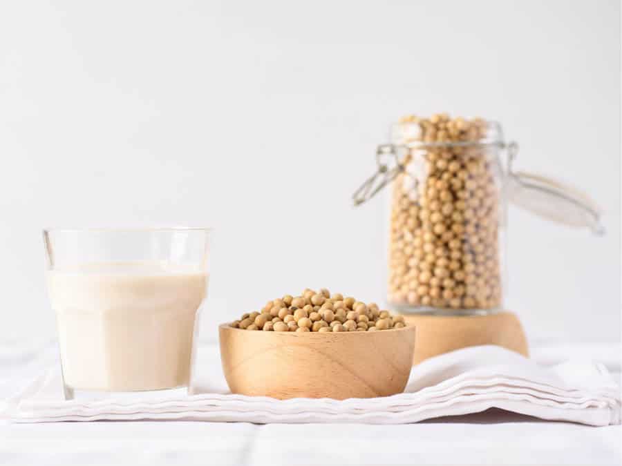 soymilk and soy beans on a white background