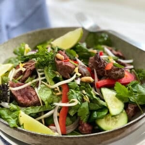 Thai Beef Salad on a table with a blue napkin
