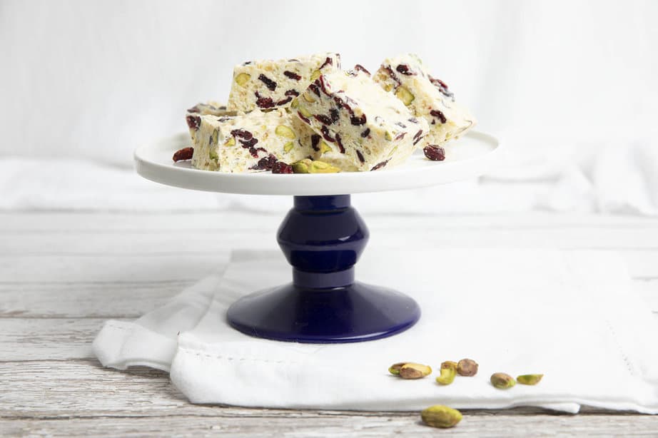 Landscape image of white Christmas recipe being presented on a cake stand