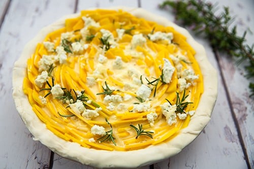 Pumpkin and Feta pie before baking on a wood background