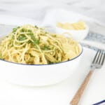 Boiled Spaghetti in a boil with seasoning on a white background