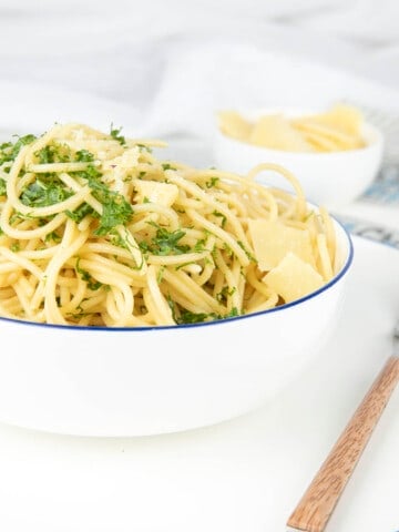 Boiled Spaghetti in a boil with seasoning on a white background