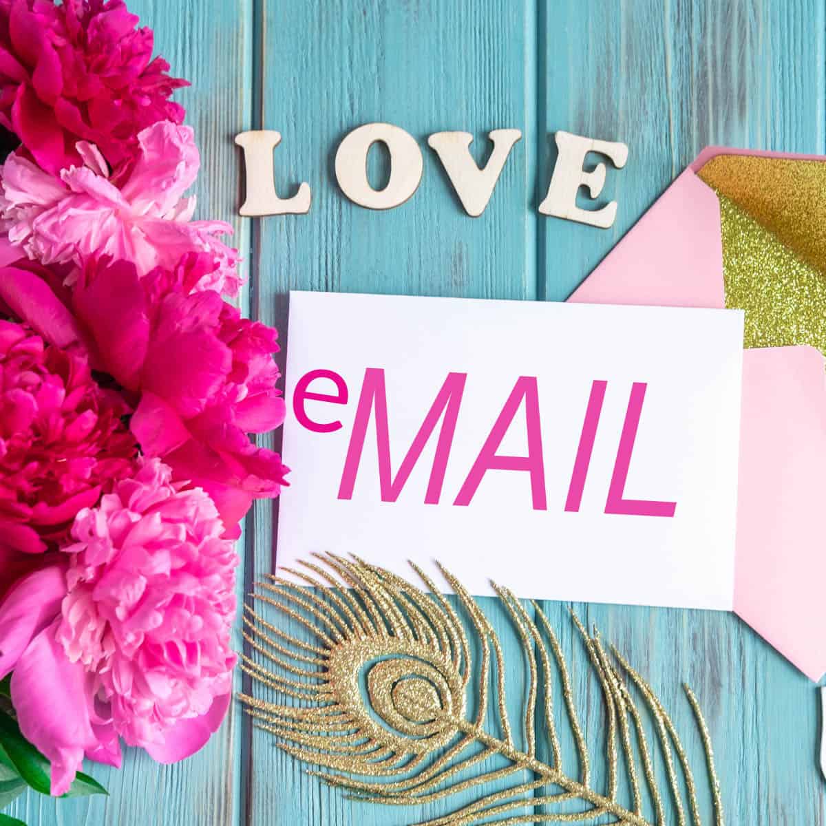 email newsletter and an envelope with love lettering on a board