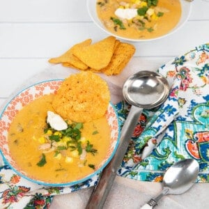 Portrait image Mexican Chicken soup in a coloured bowl with patterned napkin