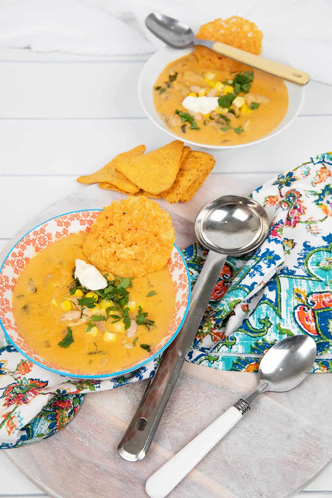 Portrait image Mexican Chicken soup in a coloured bowl with patterned napkin