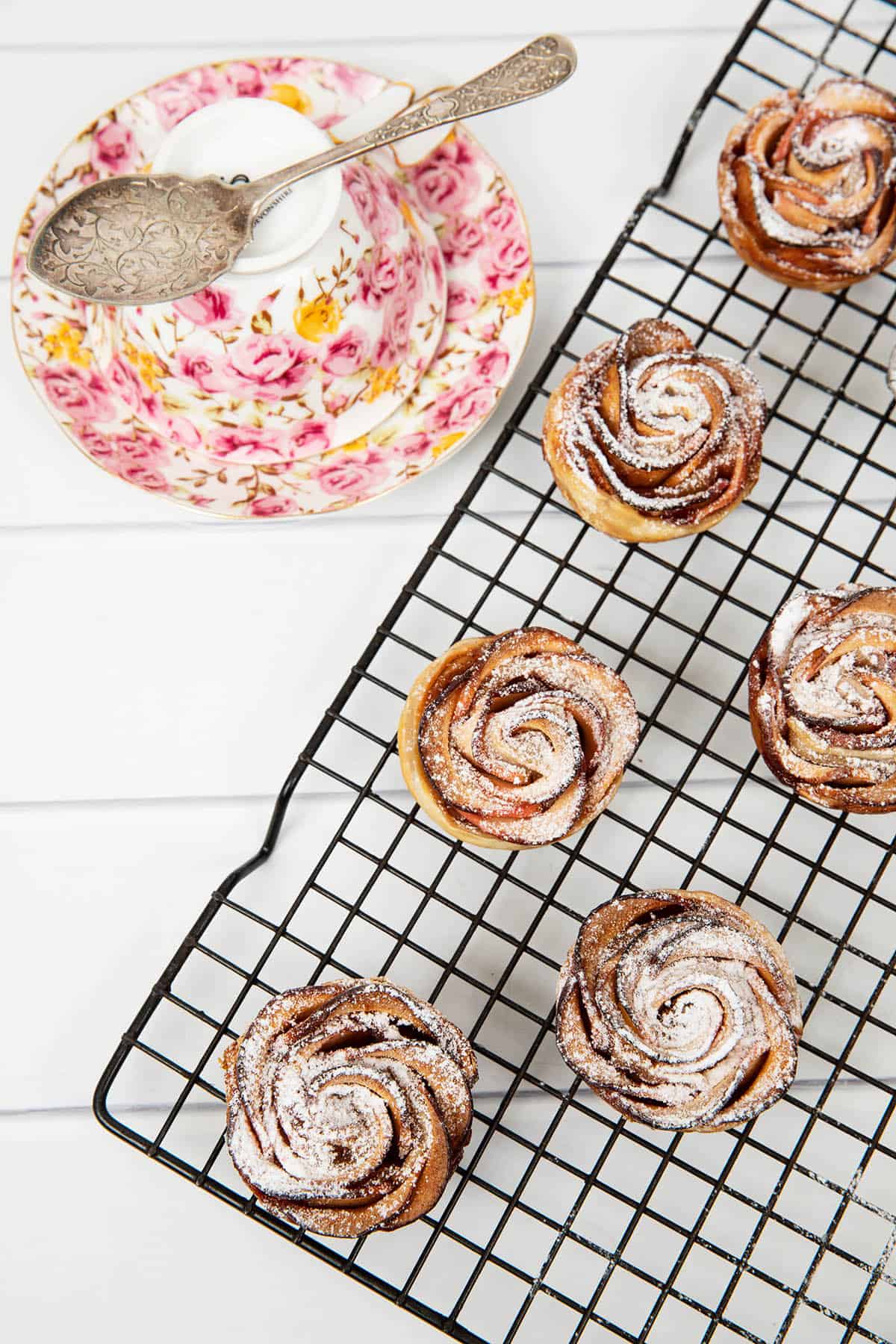 Overhead image of apple pastries with a cup of tea.