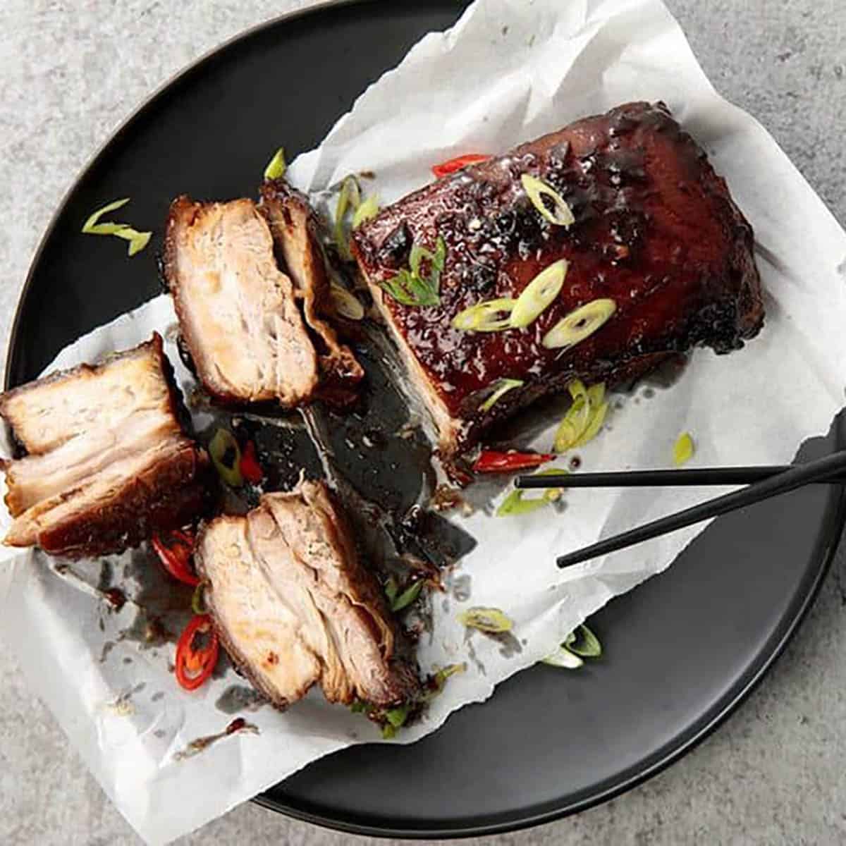 Glazed Twice Cooked Pork Belly on a black background- Main meals profile Pic