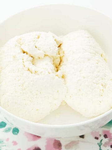 Homemade Thermomix Ricotta in a white bowl on a floral plate.