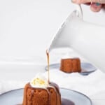 Sticky date pudding Pouring caramel sauce out of a white jug