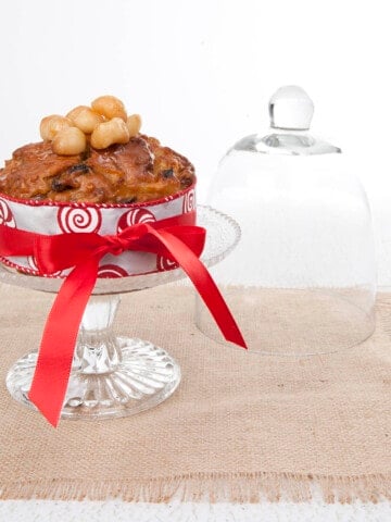 Square image of the honey and macadamia Thermomix Christmas cake with a ribbon tied around it.