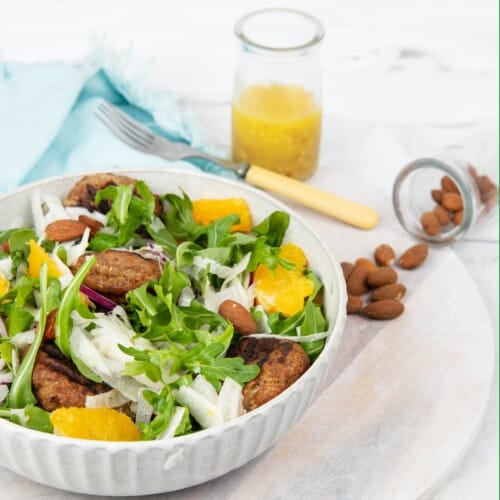 Fennel and orange salad on a white background with blue napkin