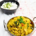 Curried Chicken Risotto in an Indian bowl with yoghurt in the background