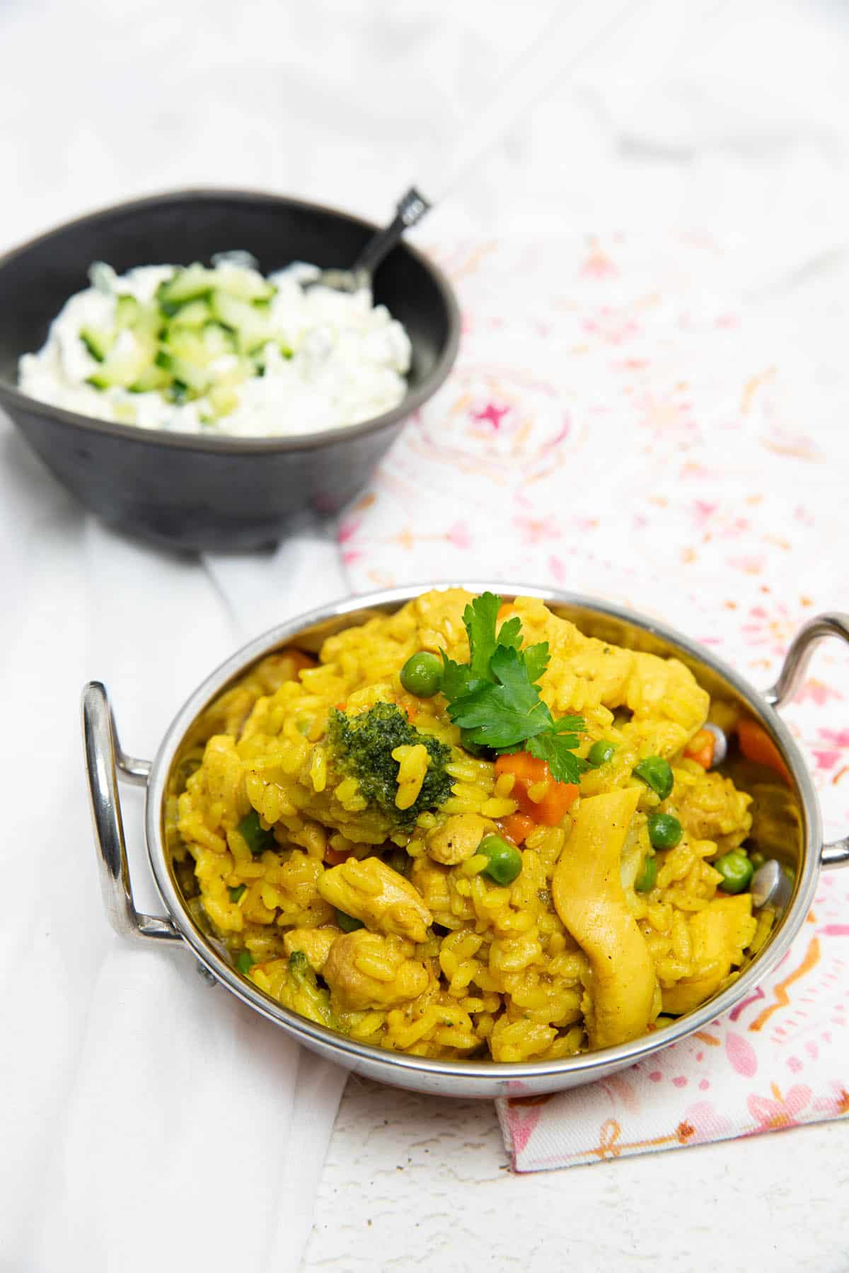 Curried Chicken Risotto in an Indian bowl with yoghurt in the background