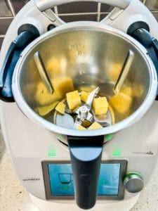 Cubed parmesan cheese in the Thermomix bowl