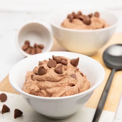 Thermomix Milo Mousse Recipe in a white bowl with chocolate chips on top.