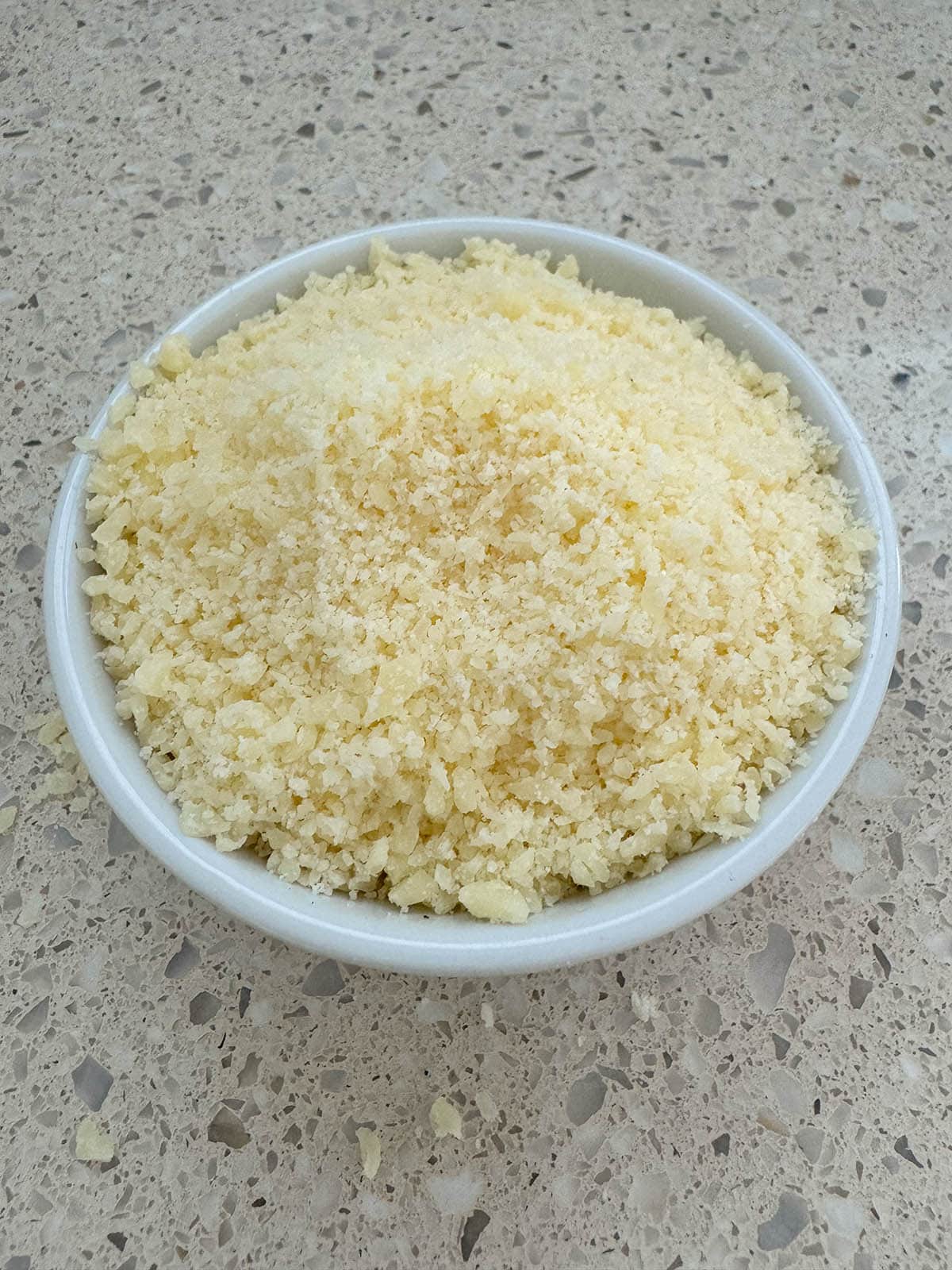 Grated parmesan cheese in a bowl.