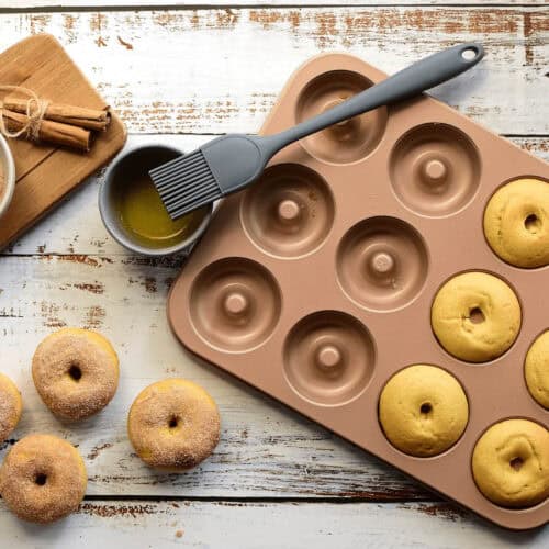 Rose Gold Donut Tray 12 hole with donuts in the hole and on the backdrop