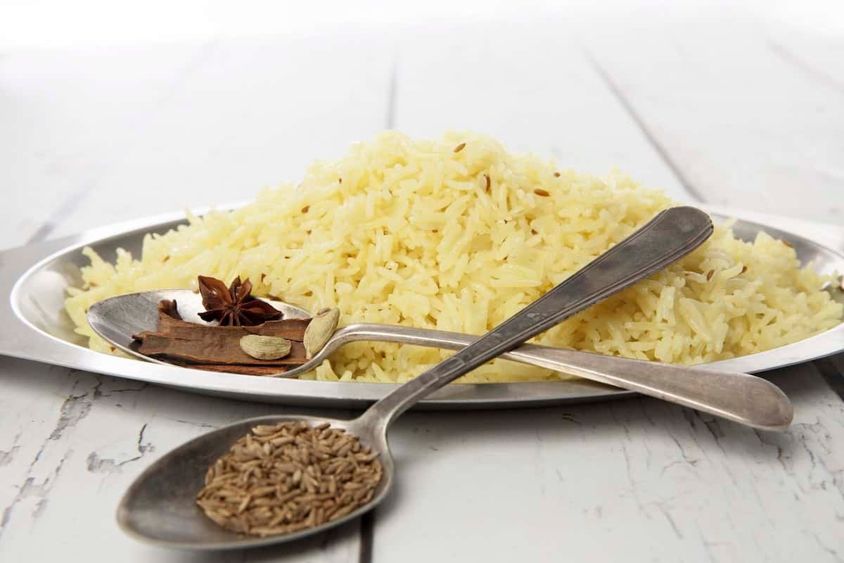 Saffron Butter Rice on a white background with whole spices